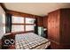 Bedroom featuring natural light, wood walls and lots of windows at 9464 N State Rd 135, Morgantown, IN 46160