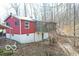 Charming red home features a cozy screened porch, perfect for enjoying peaceful outdoor moments at 9464 N State Rd 135, Morgantown, IN 46160