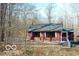 Exterior shot of red home featuring white shutters and stairs to front door at 9464 N State Rd 135, Morgantown, IN 46160