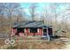 Exterior view of red house with a gray roof featuring white window shutters at 9464 N State Rd 135, Morgantown, IN 46160