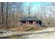 Charming one-story home featuring a long gravel driveway and wooded surroundings at 9464 N State Rd 135, Morgantown, IN 46160