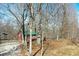 View of a matching shed adjacent to gravel drive surrounded by trees at 9464 N State Rd 135, Morgantown, IN 46160