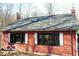 Close-up of exterior with black framed windows and red painted wood siding at 9464 N State Rd 135, Morgantown, IN 46160