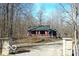 Exterior of a home on a gravel driveway with stone pillars and a wooden fence at 9464 N State Rd 135, Morgantown, IN 46160