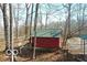 The exterior features a quaint red shed with a green roof, surrounded by bare trees and a natural landscape at 9464 N State Rd 135, Morgantown, IN 46160