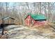 Exterior view of the property with an old shed and a gravel parking area at 9464 N State Rd 135, Morgantown, IN 46160