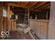 The rustic interior highlights wooden studs, an unfinished bar, and a ladder amidst natural light at 9464 N State Rd 135, Morgantown, IN 46160
