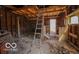Raw interior space featuring unfinished wooden framework and a ladder, showing great potential for renovation at 9464 N State Rd 135, Morgantown, IN 46160