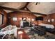 Bright living room featuring wood accents, a stone fireplace, and an open layout ideal for relaxation and entertaining at 9464 N State Rd 135, Morgantown, IN 46160