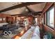 Inviting living room with wood paneling, vaulted ceilings, and views into the kitchen and towards the exterior scenery at 9464 N State Rd 135, Morgantown, IN 46160