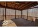 Large screened-in porch with wooden flooring and a view of the wooded backyard at 9464 N State Rd 135, Morgantown, IN 46160