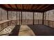 Spacious screened-in porch with wood flooring, railing, and views of surrounding woods at 9464 N State Rd 135, Morgantown, IN 46160