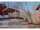 A view of the yard with a garage or shed and a red house at 9464 N State Rd 135, Morgantown, IN 46160