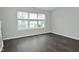 Bright bedroom with hardwood floors, neutral paint, and large windows at 9685 Glowing Flame Dr, Fishers, IN 46037