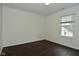 Bright bedroom with dark wood flooring, large window, and neutral wall color at 9685 Glowing Flame Dr, Fishers, IN 46037