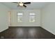 A spacious bedroom with dark wood flooring and two windows for natural light at 9685 Glowing Flame Dr, Fishers, IN 46037