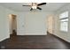 Bedroom with dark wood flooring, fan, and natural light; access to door at 9685 Glowing Flame Dr, Fishers, IN 46037