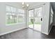 Bright dining area features a sliding glass door, large window, and stylish chandelier at 9685 Glowing Flame Dr, Fishers, IN 46037
