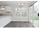 Dining area with modern chandelier, large window, and sliding glass door to backyard at 9685 Glowing Flame Dr, Fishers, IN 46037