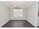 This dining room features modern chandelier, neutral paint, and sleek wood floors, perfect for entertaining at 9685 Glowing Flame Dr, Fishers, IN 46037