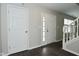 Bright entryway showcasing a white front door with glass panels, hardwood floors, and white trim at 9685 Glowing Flame Dr, Fishers, IN 46037