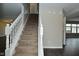 Inviting entryway featuring a carpeted staircase with white railing, complemented by neutral walls and dark hardwood flooring at 9685 Glowing Flame Dr, Fishers, IN 46037