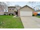 Charming two-story home with a brick and vinyl facade, complemented by a well-maintained lawn and an attached two-car garage at 9685 Glowing Flame Dr, Fishers, IN 46037