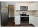 Open kitchen with white cabinets, stainless steel appliances, and views of the backyard at 9685 Glowing Flame Dr, Fishers, IN 46037