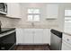 Kitchen featuring white cabinets, granite countertops, and stainless steel appliances at 9685 Glowing Flame Dr, Fishers, IN 46037