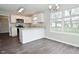 Bright kitchen with white cabinets, granite countertops, stainless appliances, and open dining area at 9685 Glowing Flame Dr, Fishers, IN 46037