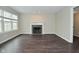 Open living room with decorative fireplace, neutral paint, and natural light at 9685 Glowing Flame Dr, Fishers, IN 46037