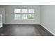 Open living space with hardwood floors, neutral paint, and large window at 9685 Glowing Flame Dr, Fishers, IN 46037