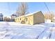 Winter backyard featuring a cozy patio area with a barbecue grill, perfect for year-round outdoor enjoyment at 115 N Spring St, Greenfield, IN 46140