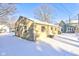 Back exterior of home with brick, plus backyard with snow on the ground at 115 N Spring St, Greenfield, IN 46140