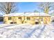 Snow-covered backyard featuring a grilling area and access door providing convenience for outdoor activities at 115 N Spring St, Greenfield, IN 46140