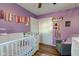Charming Bedroom with light purple walls and a white crib, creating a peaceful and inviting atmosphere at 115 N Spring St, Greenfield, IN 46140