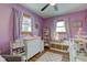 Charming Bedroom with purple walls, white furniture, and soft lighting creates a serene space at 115 N Spring St, Greenfield, IN 46140