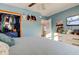 Comfortable bedroom features blue accents, ample storage, and a wall-mounted TV, creating a cozy and inviting space at 115 N Spring St, Greenfield, IN 46140