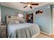 Bedroom featuring soft blue walls, plush bedding, and ample closet space for a cozy, organized room at 115 N Spring St, Greenfield, IN 46140