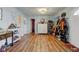 Open entryway with wood floor and white accents offer a clean and welcoming entrance to the home at 115 N Spring St, Greenfield, IN 46140