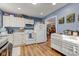 Cozy kitchen featuring white cabinets, stainless steel appliances, and wood-look flooring at 115 N Spring St, Greenfield, IN 46140