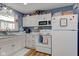 Classic kitchen with white appliances, cozy decor, and practical layout perfect for Gathering meals at 115 N Spring St, Greenfield, IN 46140