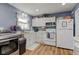 Efficient kitchen with white cabinets, modern appliances, and adjacent laundry area, a practical space at 115 N Spring St, Greenfield, IN 46140