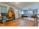 Open living space featuring hardwood floors, a couch, an armchair, and a large television at 115 N Spring St, Greenfield, IN 46140