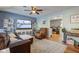 Comfortable living room with a large television, leather furniture, and an open doorway to the kitchen at 115 N Spring St, Greenfield, IN 46140