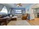 Cozy living room featuring a leather couch, accent chair, large TV, and views of the snowy outdoors at 115 N Spring St, Greenfield, IN 46140