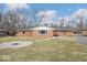 Home's backyard featuring a grassy lawn and fire pit at 1313 Oakwood Trl, Indianapolis, IN 46260