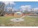 Home with a backyard, a fire pit, and a detached garage at 1313 Oakwood Trl, Indianapolis, IN 46260