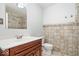 Tiled bathroom features a single sink vanity and neutral finishes at 1313 Oakwood Trl, Indianapolis, IN 46260