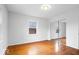 Spacious bedroom featuring wood floors and a sliding closet door at 1313 Oakwood Trl, Indianapolis, IN 46260